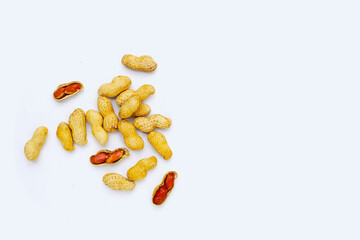 Roasted peanuts in shell on white background.