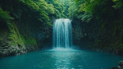 Serene waterfall cascading into a tranquil turquoise pool, surrounded by lush green tropical foliage. Sunlight filters through the canopy, creating a peaceful atmosphere.