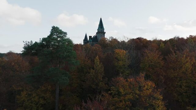 Tracking shot towards Teleborg Castle in V&auml;xjo, Sweden, Fall, Orange and Yellow Leafs