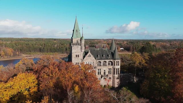 Tracking shot towards Teleborg Castle in V&auml;xjo, Sweden, Fall, Orange and Yellow Leafs