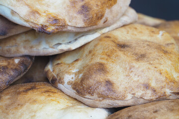 Warm and fresh baked flatbreads stacked in a local market