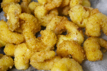 it is  cooking shrimp tempura.