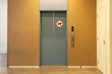 Elevator door with no pets sign in modern building interior, minima design, neutral color palette, urban setting, caution notice.