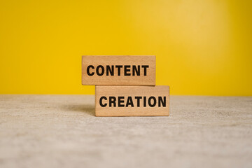 content creation words on wooden blocks on yellow background