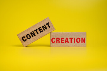 content creation words on wooden blocks on yellow background