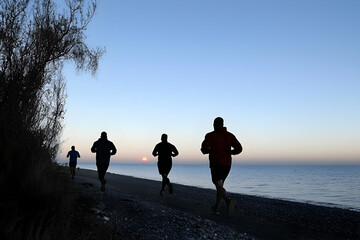 Runners on Beach at Sunrise