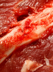 A close up of a piece of meat with red blood spots