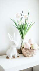Obraz premium A white rabbit sits beside a colorful basket of eggs on a table, celebrating Easter festivities.