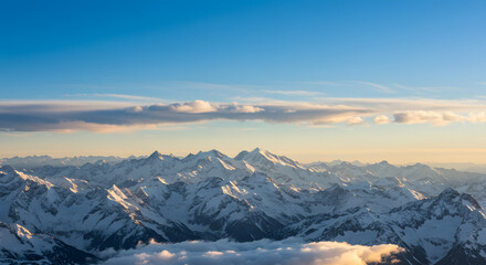 Snowy Mountain Range Peaks Under a Bright Blue Sky at Sunset