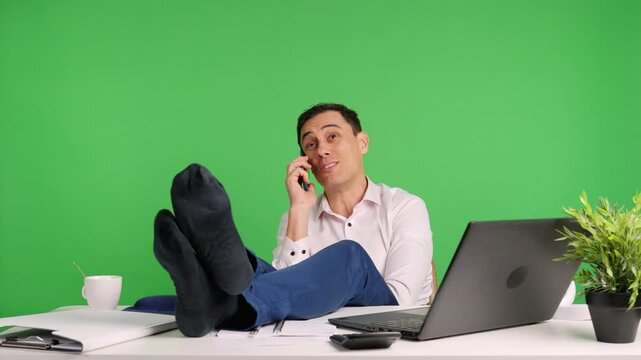 Office worker relaxing and talking on phone, then getting caught by boss