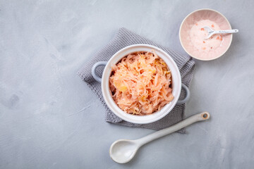 Fermented cabbage or sauerkraut in a  pot with salt
