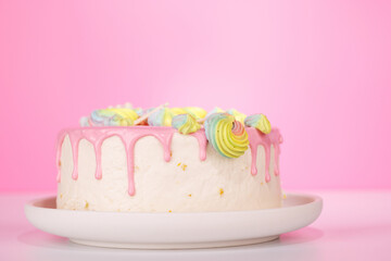 A beautifully decorated cake adorned with colorful macarons