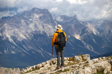 Fototapeta premium Hiker enjoys the view from Lagazuoi mountain over the italian Dolomites.