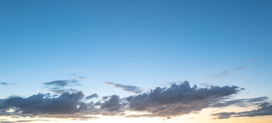 Fototapeta premium Sunset Clouds background. Dramatic Clouds Sunset Background. Sky with clouds in Sunrise. Sunrise with clouds in various shapes background. Calm Cloud.