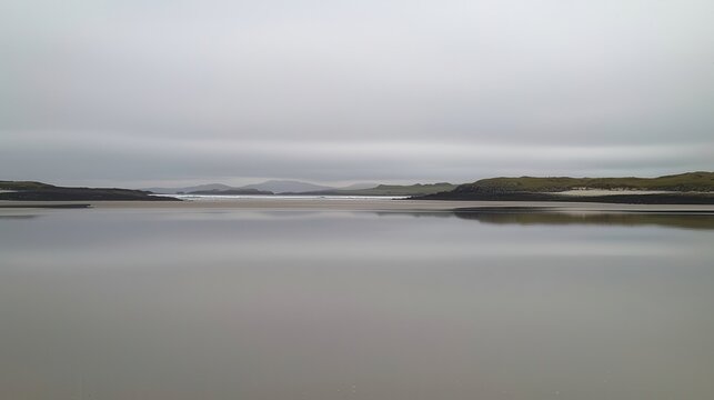 Serene Coastal Landscape Calm Waters Reflecting a Cloudy Sky and Distant Hills