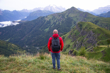 Naklejka premium Hiker enjoys the view at Passo Giau in the italian Dolomites. Adventure and travel concept