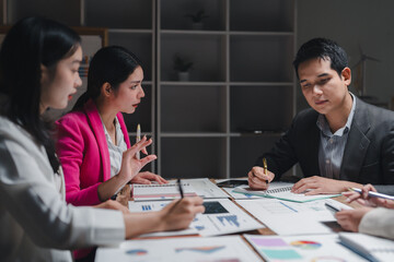 Business people working and discussing financial chart at office desk
