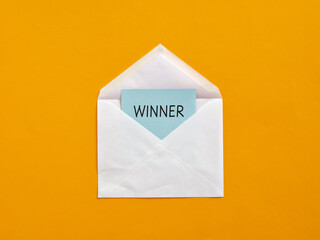 White envelope containing winner notification on orange background