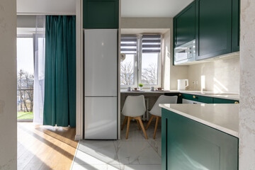 Modern Kitchen with Green Cabinets and Breakfast Bar