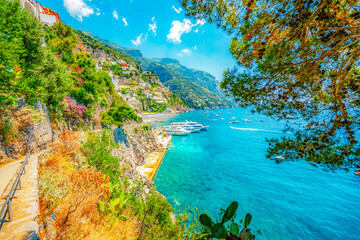 Positano coastline in south of Italy, vertiginous cliffs adorned with colorful villages, turquoise...