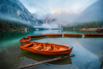 Lago di Braies or Pragser Wildsee lake with boats and fishing dock.Fanes-Sennes-Braies national park in Dolomiti Alps, South Tyrol, Italy