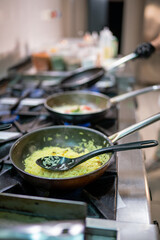 Chef cooking indian saffron rice in a professional kitchen