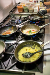 Chef cooking indian saffron rice in a professional kitchen