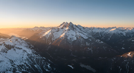 Snow Capped Mountain Range at Sunrise with Golden Light View