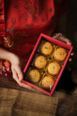 Box of Mooncake a Chinese traditional pastry for Mid-Autumn festival. set on rustic wooden table.