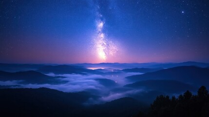 Milky Way over Misty Mountain Peaks at Night