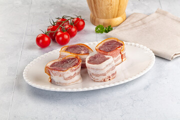 Raw pork tenferloin with bacon