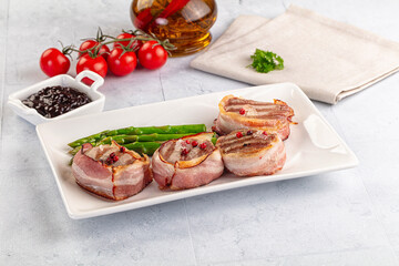 Tasty grilled pork medallion with bacon