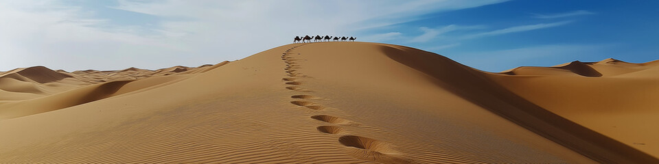 Camel caravan walking on sand dunes in desert landscape.