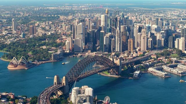 Close up zoomed drone video facing circular quay and the Sydney CBD. Features the harbour bridge as the drone flies west revealing the opera house toward the end