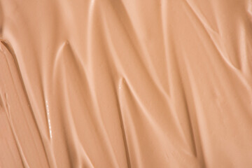 Makeup foundation texture swatch. BB cream, concealer, paint smear background. 