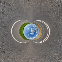 blue hole sphere or globe little planet inside grass or sand or dry ground frame background with...
