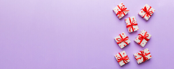 Valentine day composition: red gift box with bow and heart. Christmas present. View from above....