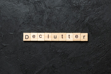 Declutter word written on wood block. Declutter text on cement table for your desing, concept