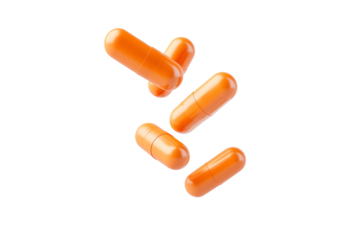 Group of orange pills are floating in the air, isolated