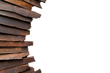 Rusty metal sheets are stacked closely, creating a visually interesting pattern with various tones and textures. The crisp white background emphasizes the industrial feel of the materials