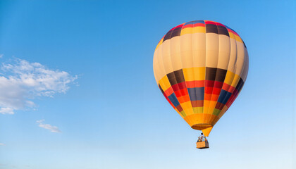 Naklejka premium Vibrant hot air balloon floating in clear blue sky, adventure and freedom