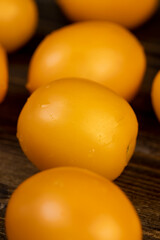 a large number of ripe orange tomatoes that are on the table