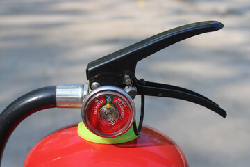 Handle and pressure gauge of a lighter fire extinguisher