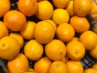 Fresh oranges stacked in a supermarket – vibrant, juicy, and packed with vitamin C for a healthy boost, Alam Sutera, Indonesia - March 16, 2025.