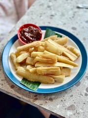 Portrait photo of crispy cassava served with spicy Roa fish sambal – a delicious Indonesian snack with a bold and smoky kick. Alam Sutera, Indonesia - March 16, 2025.