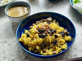 Golden Nasi Mandhi with dates and tender lamb, served with a separate lamb curry – a perfect dish for Iftar or Eid Mubarak celebrations.Alam Sutera, Indonesia - March 16, 2025.