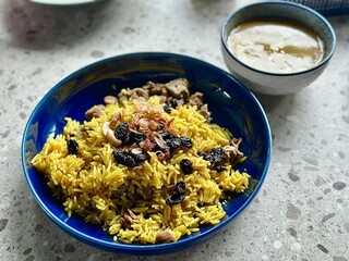 Golden Nasi Mandhi with dates and tender lamb, served with a separate lamb curry – a perfect dish for Iftar or Eid Mubarak celebrations.Alam Sutera, Indonesia - March 16, 2025.