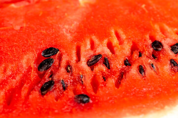 part of a sliced juicy watermelon with black seeds