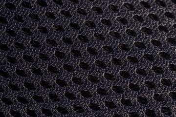 There is a thin mesh for ventilation of black sports shoes
