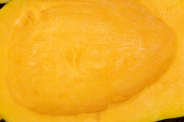 freshly cut orange pumpkin with cooking seeds